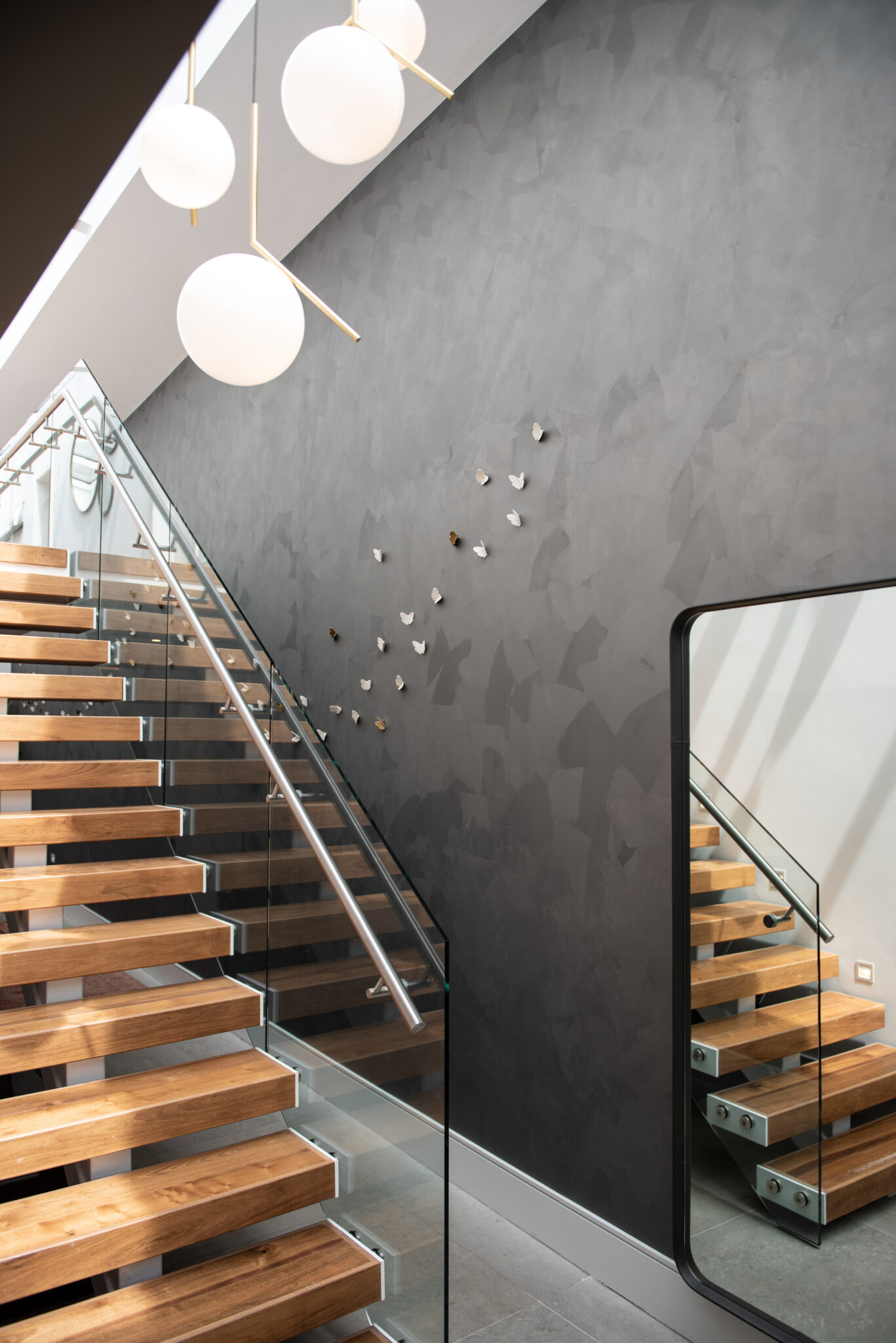 image showing a modern staircase and butterfly ceramic wall sculptures